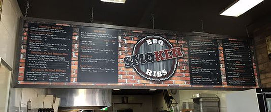 printed restaurant menu boards suspended from ceiling