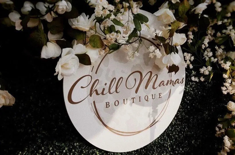 Custom business logo sign shown with flowers.