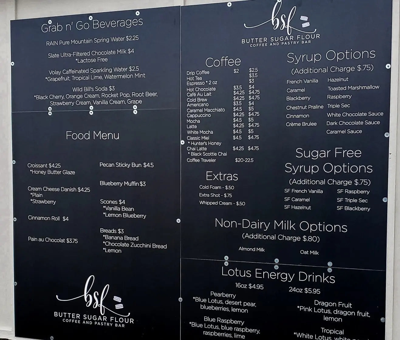 Custom menu boards for a restaurant printed in black and white in an outdoor display.