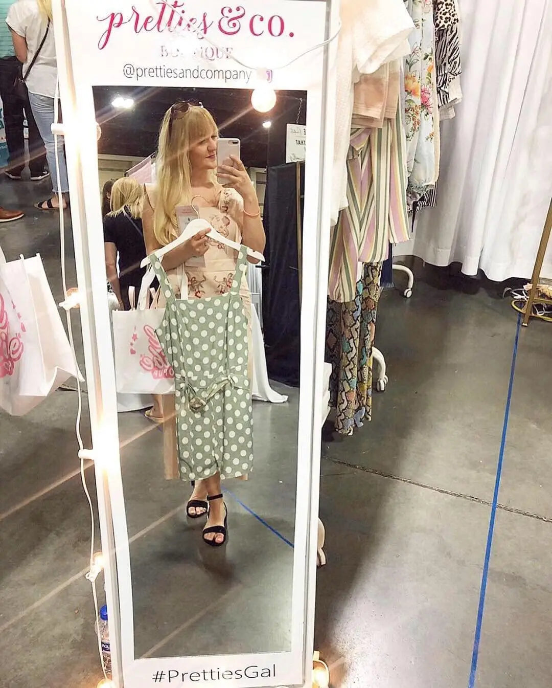 Custom Selfie Station Mirror Cling in boutique smiling woman taking photo while shopping.