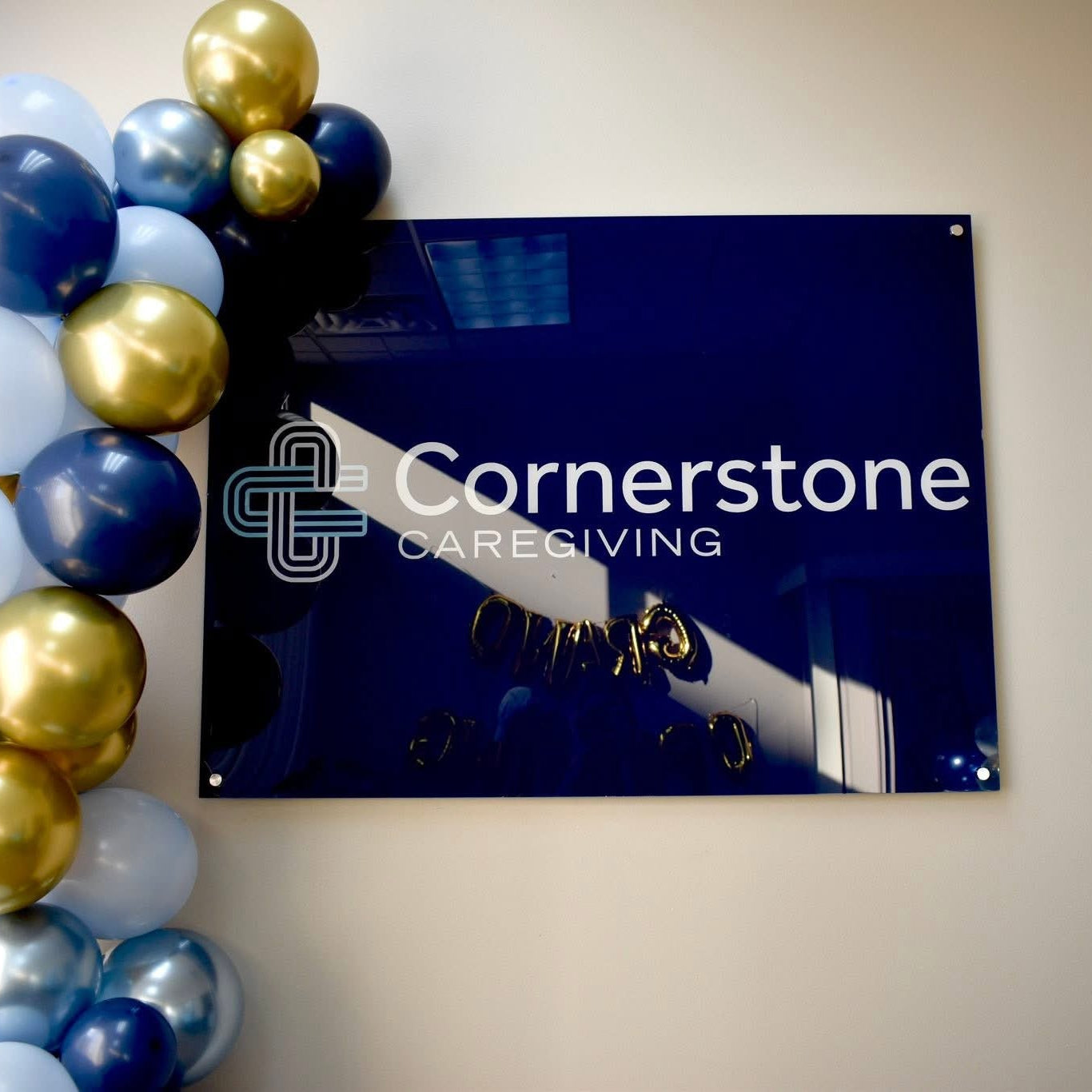 acrylic business sign custom logo with standoffs mounted to wall 